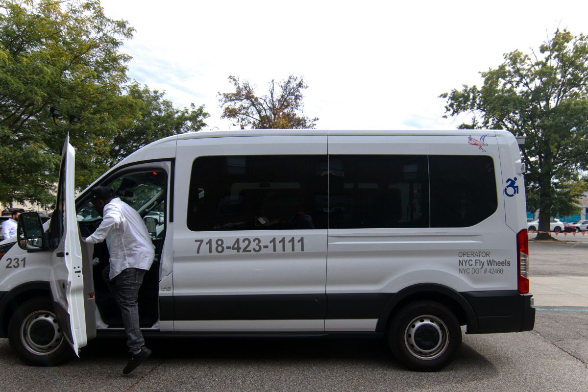 A man entering an ambulette through the front door.