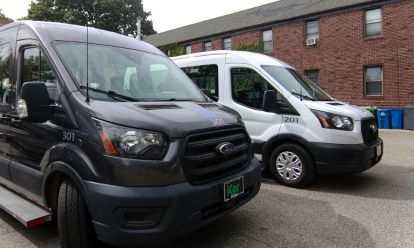 one white and black color cars parked in a row ready for transportation service